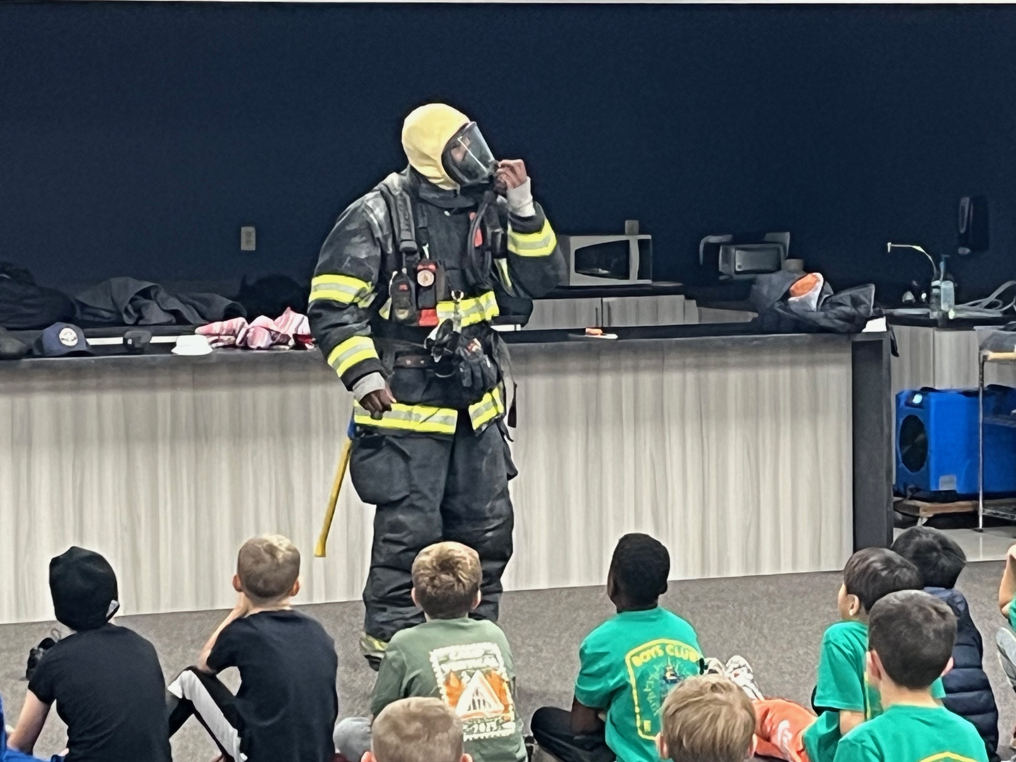 Fire fighter with children at Boys Club
